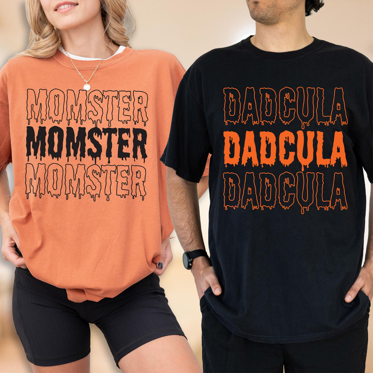 May include: Two t-shirts, one orange and one black, with Halloween-themed text. The orange shirt says "MOMSTER" three times in black dripping font. The black shirt says "DADcula" three times in orange dripping font. Both shirts are short-sleeved.