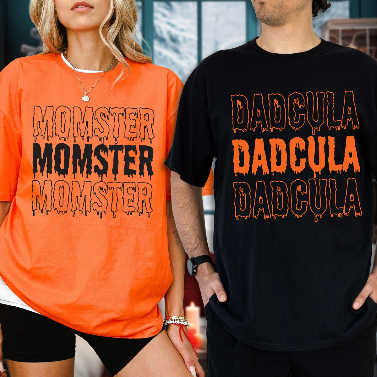 May include: Two short-sleeved t-shirts. One is orange with the word "MOMSTER" printed three times in black. The other is black with the word "DADcula" printed three times in orange. Both shirts are for Halloween.