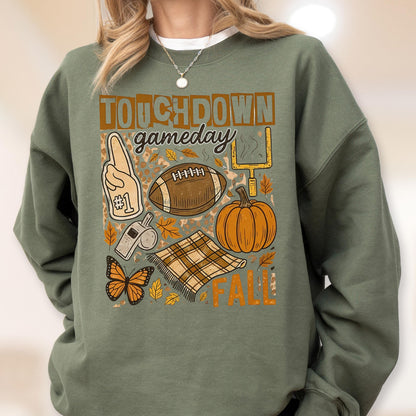 May include: Green sweatshirt with a graphic design featuring the words "TOUCHDOWN gameday FALL". The design includes a football, pumpkin, foam finger, whistle, butterfly, and a plaid blanket.