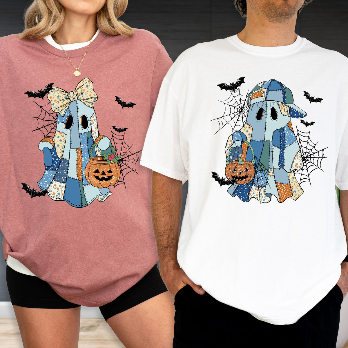 May include: Two Halloween-themed shirts. One is a dusty rose long-sleeve shirt with a ghost graphic holding a pumpkin. The other is a white t-shirt with a ghost graphic wearing a baseball cap and holding a pumpkin. Both have spiderwebs and bats.