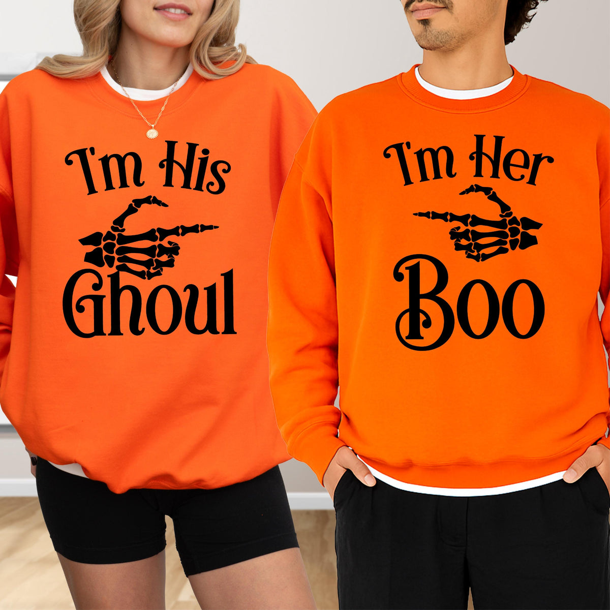 May include: Two orange sweatshirts with black text and skeleton hand graphics. One says "I'm His Ghoul" and the other says "I'm Her Boo". The sweatshirts are a Halloween-themed couple's outfit.
