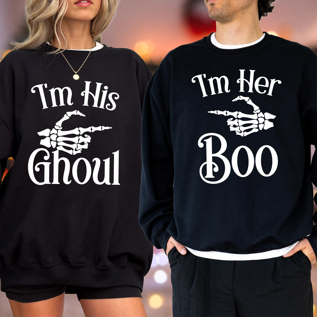 May include: Black sweatshirts with white text and skeleton hand graphics. One says "I'm His Ghoul" and the other says "I'm Her Boo". Both have white trim around the collar.