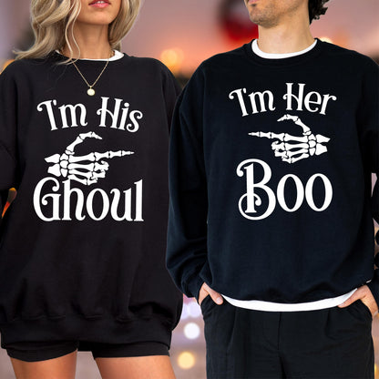 May include: Black sweatshirts with white text and skeleton hand graphics. One says "I'm His Ghoul" and the other says "I'm Her Boo". Both have white trim around the collar.