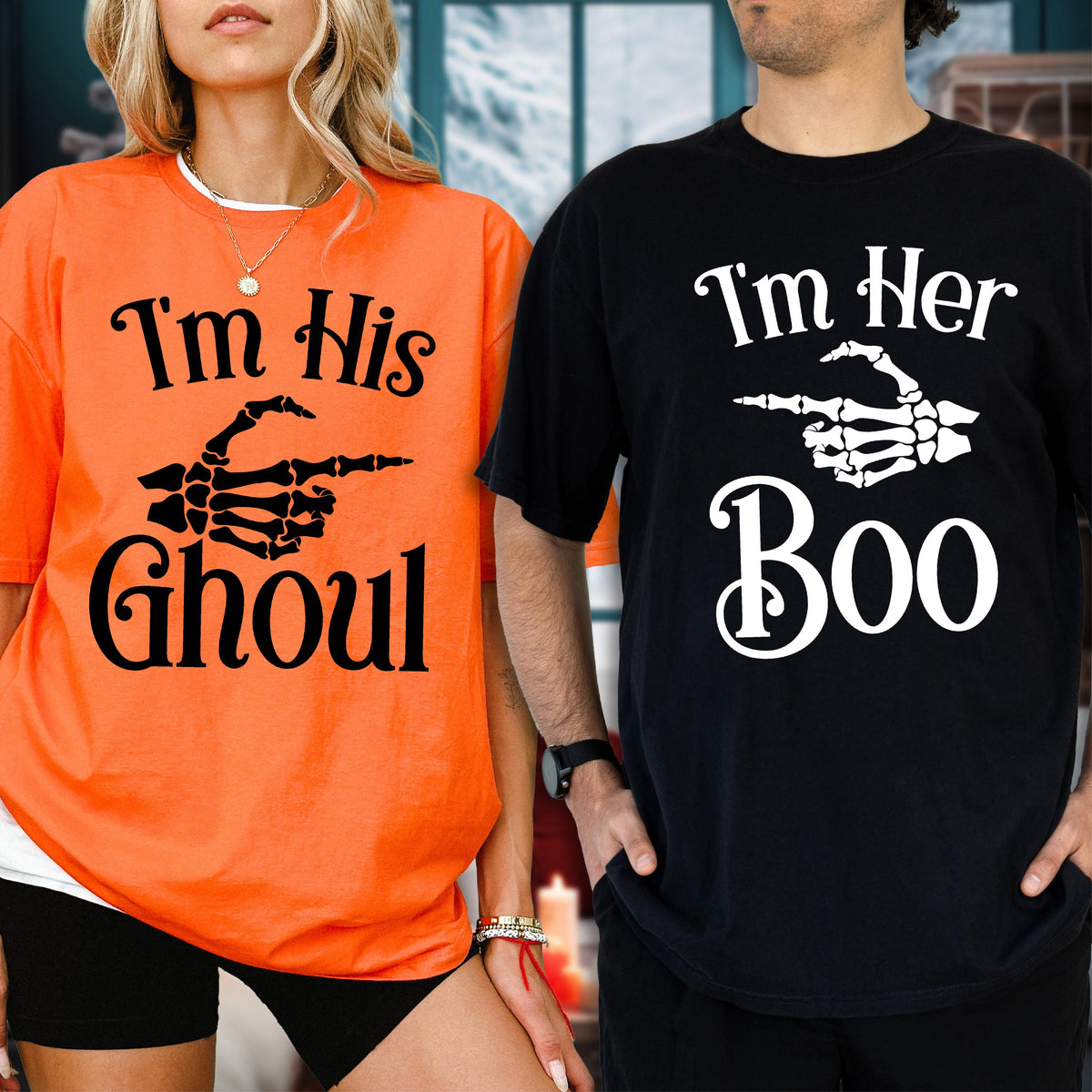 May include: An orange t-shirt with black text reading I'm His GHOUL and a black skeleton hand graphic, alongside a black t-shirt with white text reading I'm Her Boo and a white skeleton hand graphic pointing to the side on both shirts.