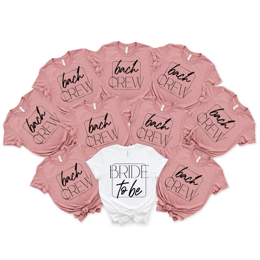 May include: Eight pink t-shirts with the text 'bach crew' in a black square and one white t-shirt with the text 'bride to be' in a black square.