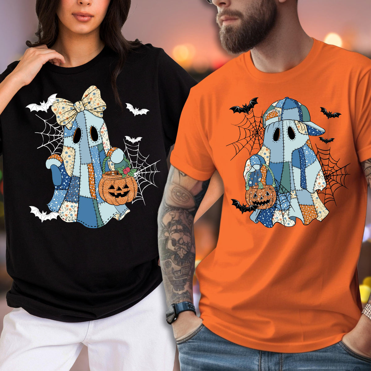 May include: A black t-shirt and an orange t-shirt, each featuring a graphic of a blue patchwork ghost holding a jack-o'-lantern. The ghost on the black shirt wears a bow, while the ghost on the orange shirt wears a baseball cap, both surrounded by spiderwebs and bats.