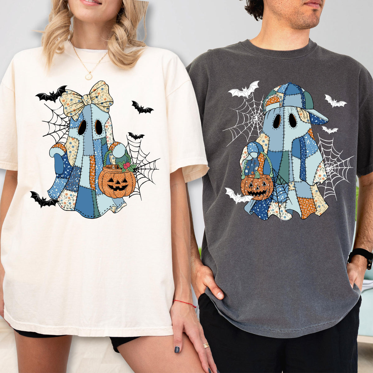 May include: Two t-shirts, one cream and one charcoal gray, each featuring a graphic of a patchwork ghost holding a jack-o'-lantern. The ghost on the cream shirt wears a large bow, while the ghost on the gray shirt wears a baseball cap. Both designs include spiderwebs and flying bats.