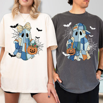 May include: Two t-shirts, one cream and one charcoal gray, each featuring a graphic of a patchwork ghost holding a jack-o'-lantern. The ghost on the cream shirt wears a large bow, while the ghost on the gray shirt wears a baseball cap. Both designs include spiderwebs and flying bats.