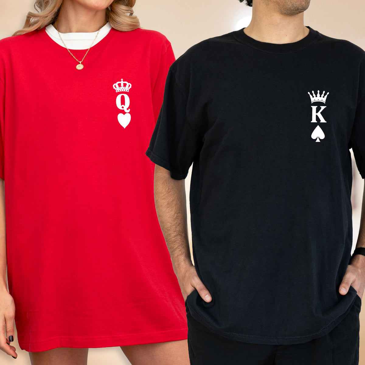 May include: Two short-sleeved t-shirts, one red and one black. The red shirt has a white collar and a white graphic of a crown, the letter "Q", and a heart. The black shirt has a white graphic of a crown, the letter "K", and a spade.