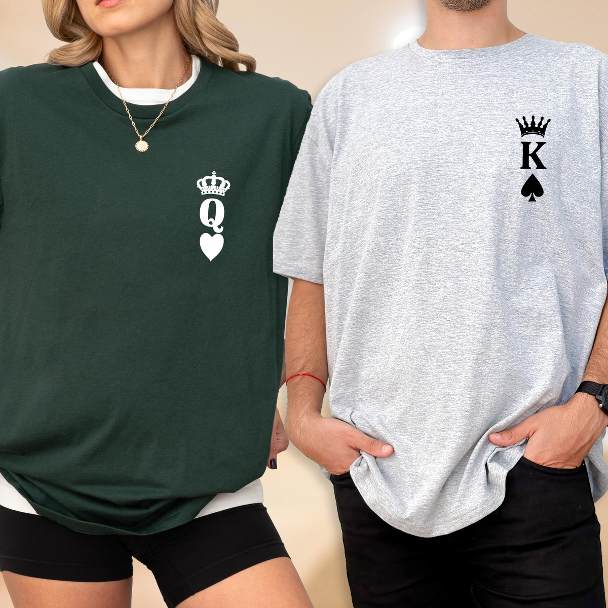 May include: Two matching t-shirts, one dark green and one light gray. The dark green shirt features a white crown, the letter "Q", and a heart. The light gray shirt has a white crown, the letter "K", and a spade.