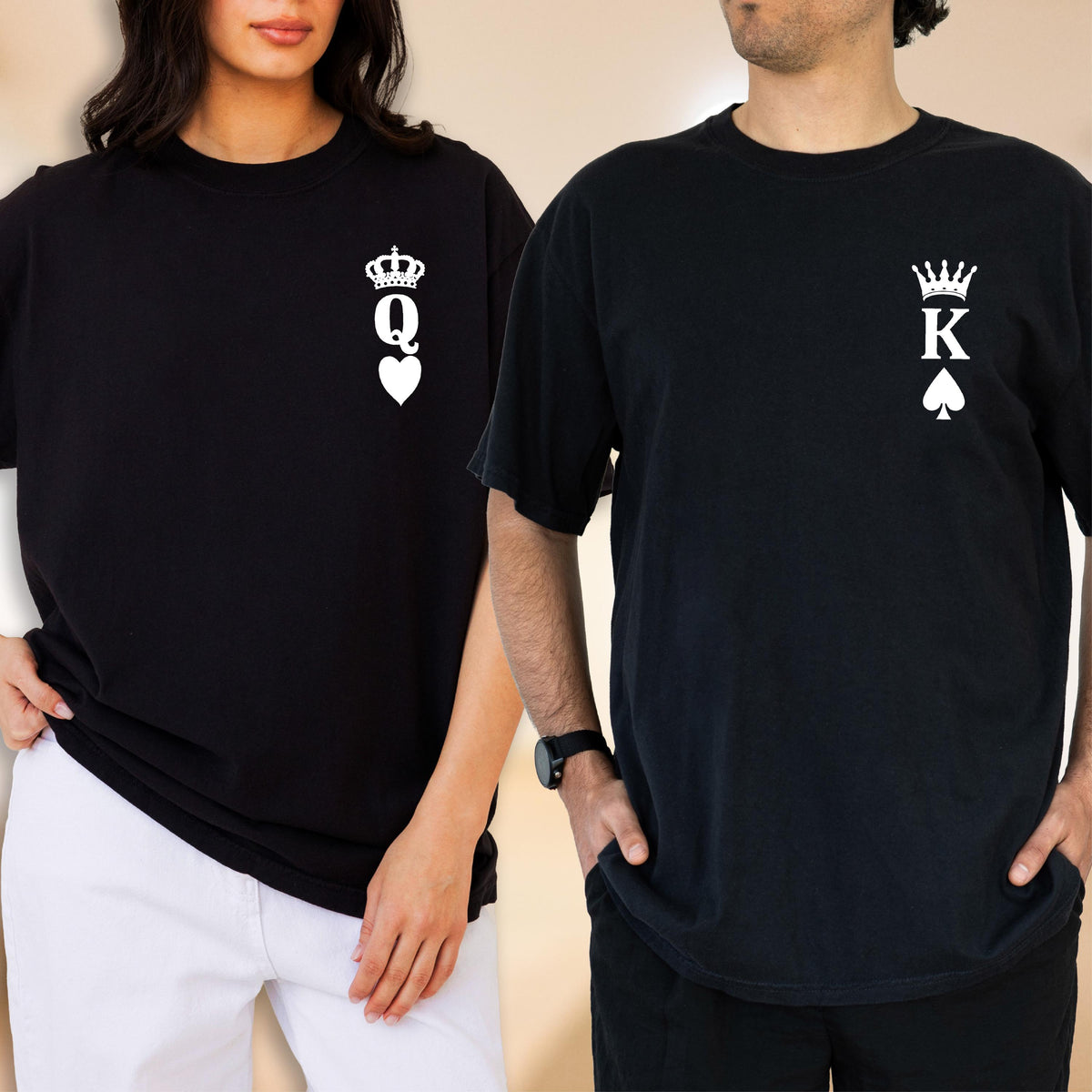 May include: Two black short-sleeve t-shirts. The left shirt features a white graphic of a crown above the letter Q and a heart symbol. The right shirt features a white graphic of a crown above the letter K and a spade symbol on the chest area.