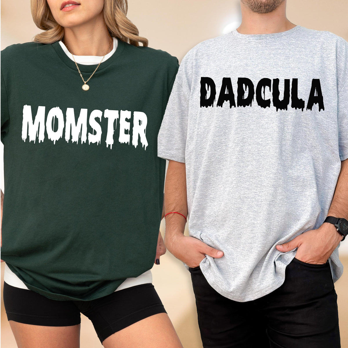 May include: A dark green t-shirt with the white text MOMSTER in a dripping font and a light gray t-shirt with the black text DADCULA in a dripping font. Both shirts feature a crew neckline and short sleeves, showcasing a graphic design style.