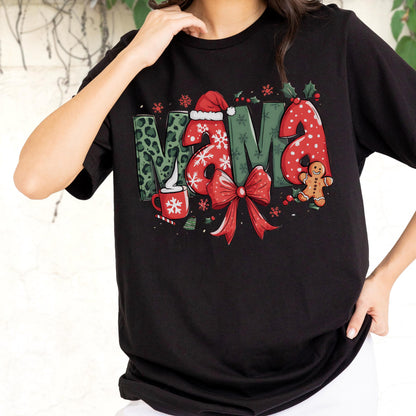 May include: Black t-shirt with a festive "MAMA" graphic. The letters feature a mix of patterns, including leopard print and polka dots, with a Santa hat on the "A". Includes a red bow, gingerbread man, and snowflakes, perfect for the holiday season.