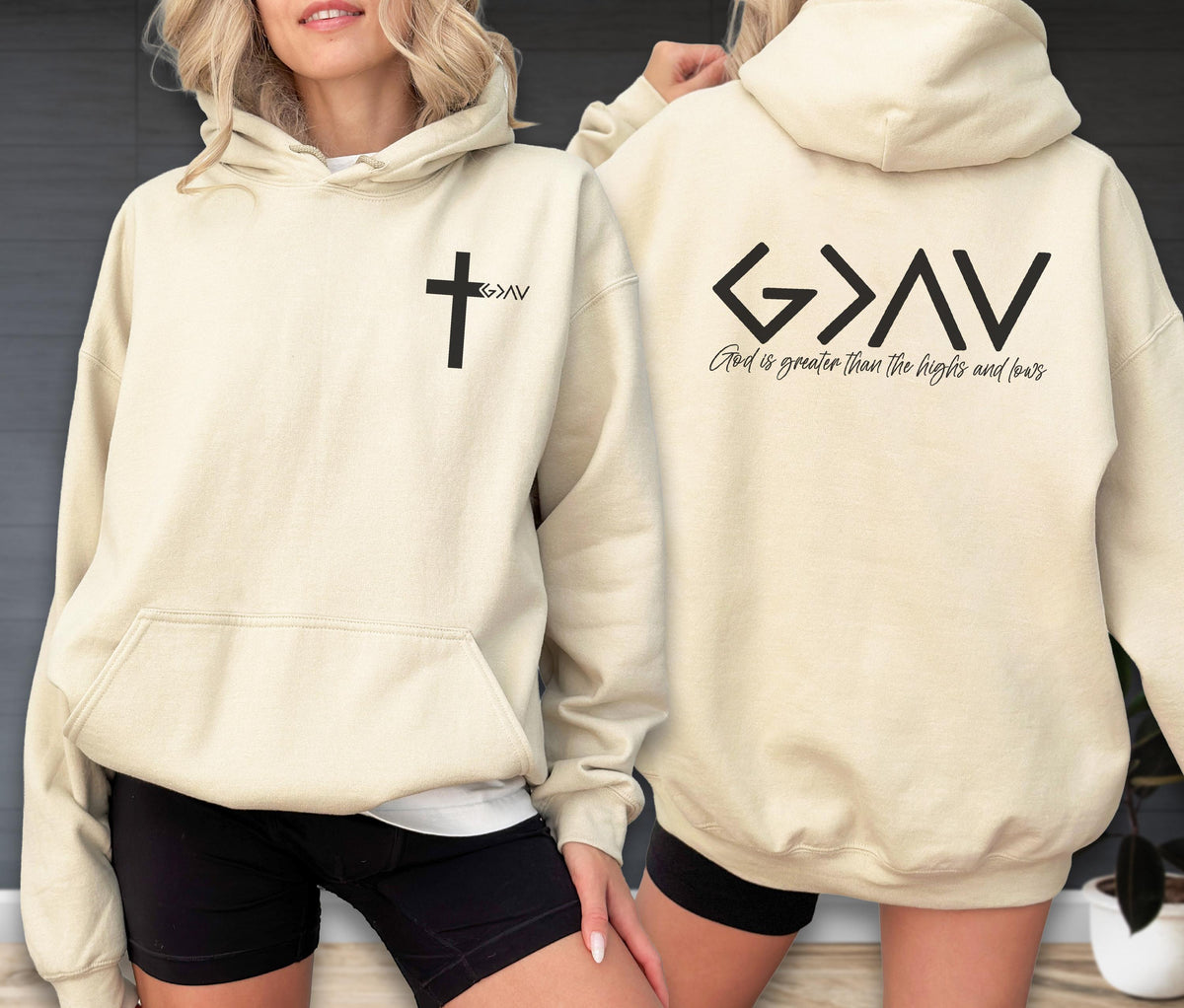 May include: A cream-colored hooded sweatshirt featuring a black cross graphic with the text G>AV on the front left chest. The back displays the large black text G>AV with the phrase God is greater than the highs and lows printed below it.