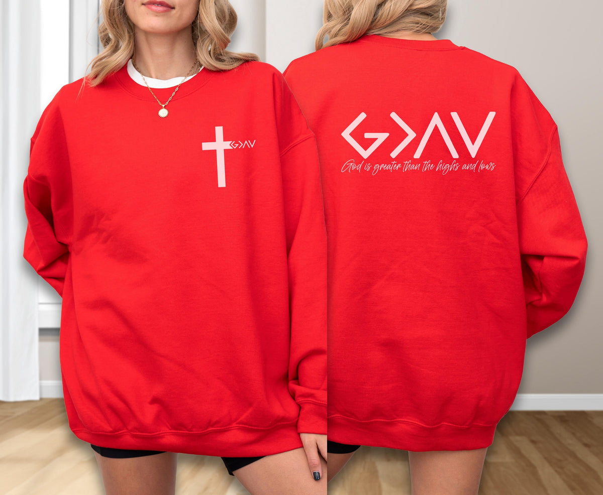 May include: A bright red crewneck sweatshirt featuring a white graphic on the front left chest of a cross and the text G>AV. The back displays a large white G>AV symbol with the text God is greater than the highs and lows printed below it.