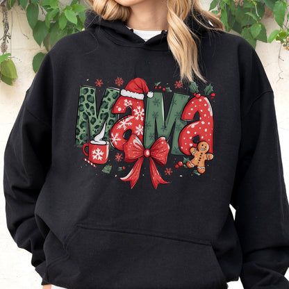 May include: Black hoodie with the word "MAMA" in a festive Christmas design. The letters feature a mix of patterns, including leopard print, snowflakes, and red polka dots. A red bow, gingerbread man, and a cup of cocoa complete the holiday theme.