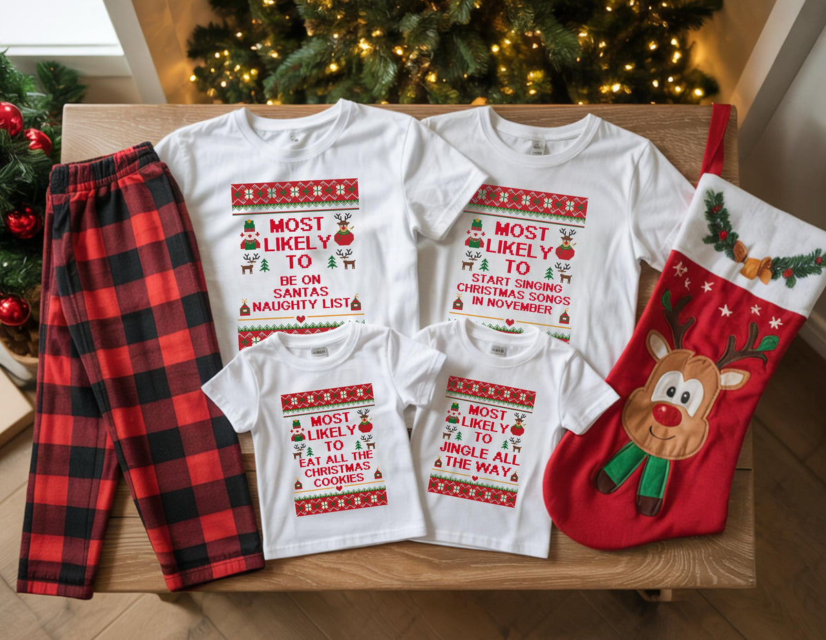 May include: A collection of Christmas-themed apparel, including white t-shirts with festive text and a red and black plaid pajama set. The shirts feature phrases like "Most Likely to be on Santa's Naughty List" and "Most Likely to Start Singing Christmas Songs". A red Christmas stocking is also included.