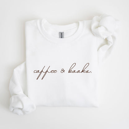 May include: White crew neck sweatshirt with the words "coffee & books" in a brown script font. The sweatshirt is made of a soft material and has a relaxed fit. The sleeves are folded over.