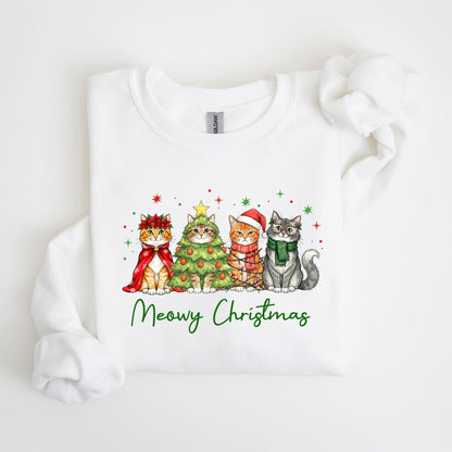 May include: White sweatshirt featuring a festive design with four cats. Each cat is dressed in holiday attire, including a cape, a Christmas tree costume, a Santa hat, and a scarf. The words "Meowy Christmas" are written in green script below the cats.