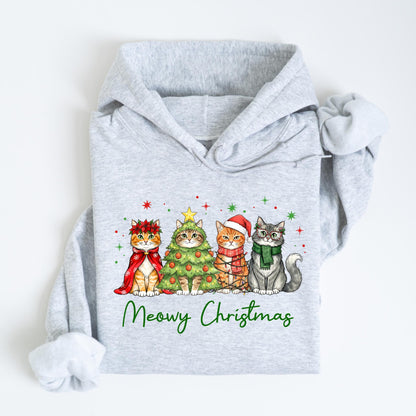 May include: A light gray hoodie featuring a festive design with four cats dressed for Christmas. The cats are adorned with holiday accessories, including a wreath, a Christmas tree costume, a Santa hat, and a scarf. The text "Meowy Christmas" is written in green below the cats.