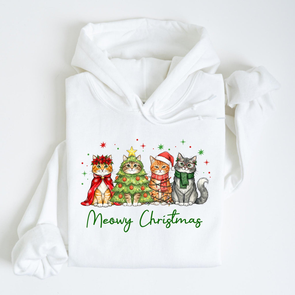 May include: White hoodie featuring a festive graphic of four cats. Each cat is dressed in holiday attire, including a Christmas tree, a Santa hat, and scarves. The phrase "Meowy Christmas" is written in green script below the cats.