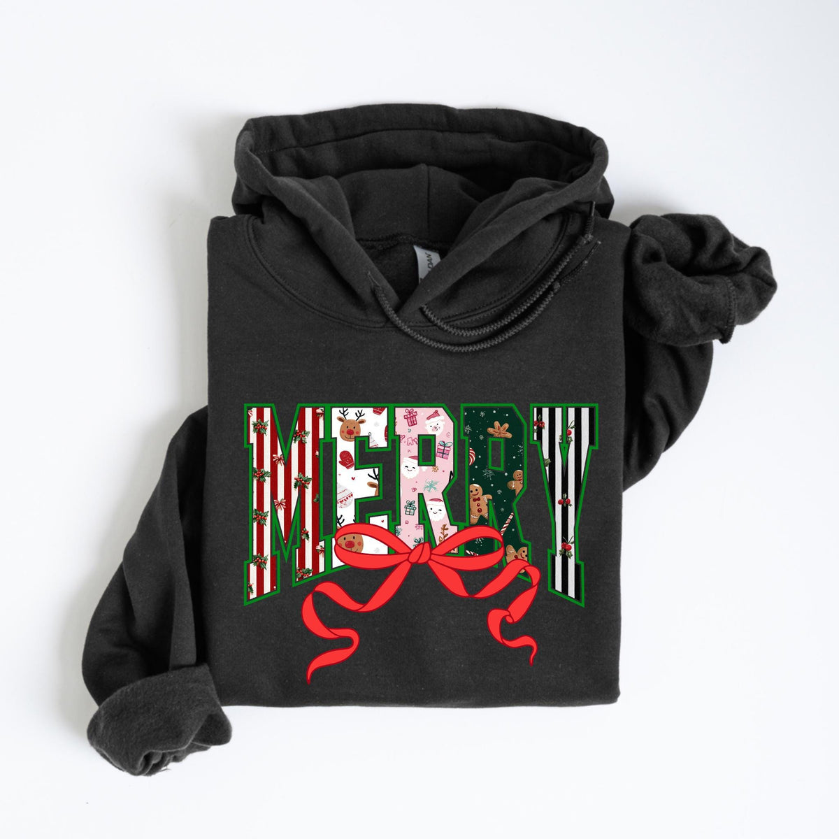 May include: A dark gray hoodie with the word "MERRY" in a festive design. The letters are filled with Christmas patterns, including reindeer, gifts, and gingerbread men. A red bow is at the bottom of the word.