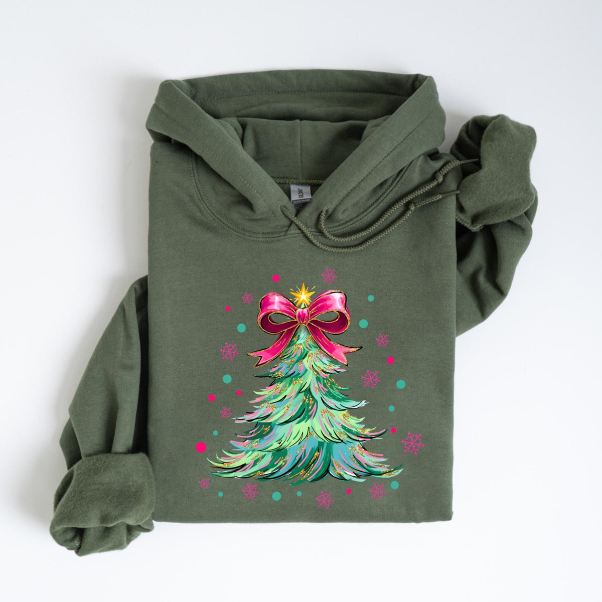 May include: An olive green hoodie featuring a Christmas tree design. The tree is decorated with a pink bow, a gold star, and colorful accents. The hoodie has a drawstring hood and a kangaroo pocket.