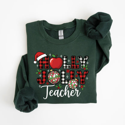 May include: Dark green sweatshirt with the words "HOLLY JOLLY Teacher" in a festive design. The design includes a red apple, Santa hat, and ornaments. The letters are red and black plaid.