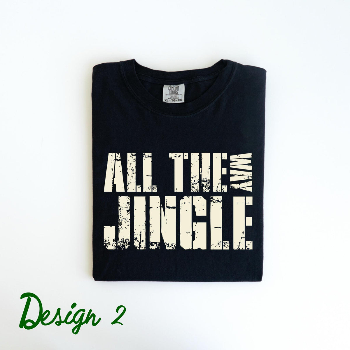 May include: Black t-shirt with the text "ALL THE JUNGLE WAY" in a distressed, off-white font. The words are stacked vertically, with "WAY" on the right side. The design is labeled "Design 2" in green script at the bottom.