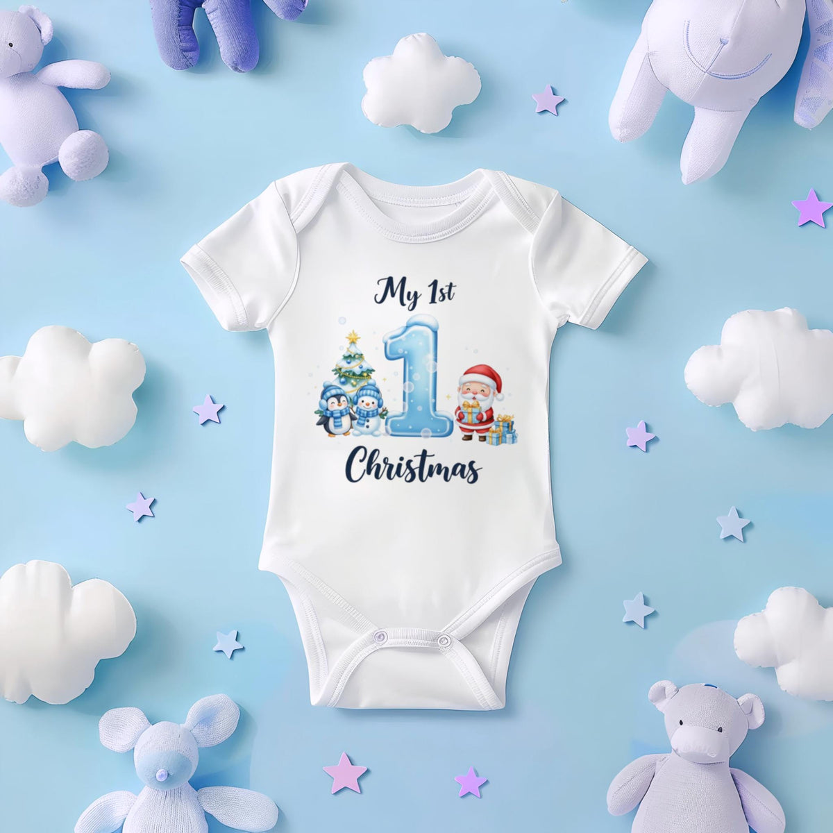 May include: White baby onesie with a festive Christmas design. The onesie features the text "My 1st Christmas" with a large number 1, penguins, a Christmas tree, and Santa Claus. The onesie is surrounded by plush toys and star-shaped decorations.
