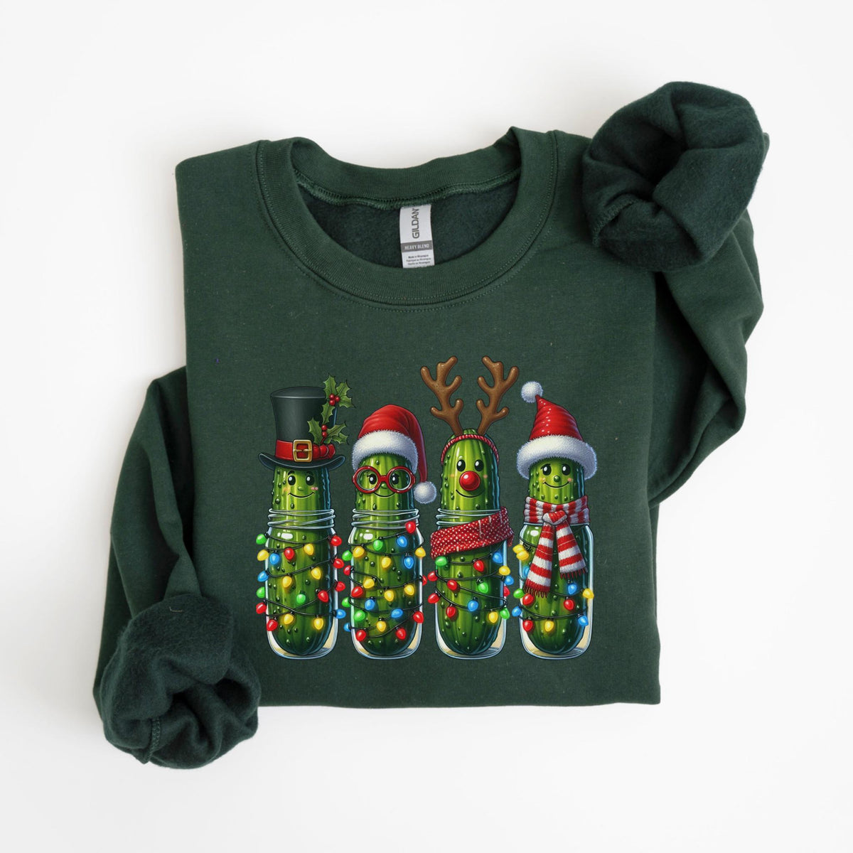 May include: Dark green sweatshirt featuring a festive design of four anthropomorphic pickles in mason jars, each adorned with Christmas accessories like a top hat, Santa hat, reindeer antlers, and a scarf. The pickles are decorated with colorful Christmas lights.