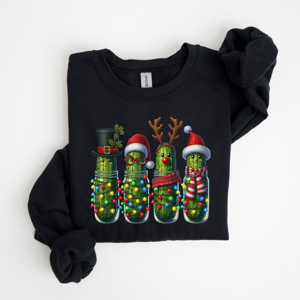 May include: Black sweatshirt featuring a festive design of four anthropomorphic pickles in glass jars, each adorned with Christmas decorations. The pickles are wearing hats, glasses, antlers, and scarves, and are surrounded by colorful string lights.