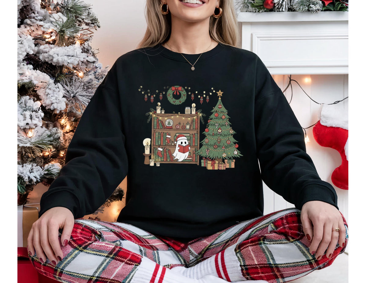 May include: Black sweatshirt with a Christmas-themed graphic. The design features a decorated Christmas tree, a bookshelf with a ghost wearing a Santa hat, and holiday decorations. The sweatshirt is paired with red and white plaid pajama pants.