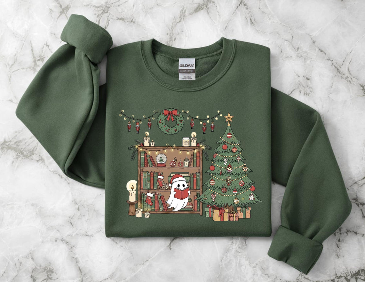 May include: Green sweatshirt with a festive Christmas design. The graphic features a ghost reading a book in front of a bookshelf, a decorated Christmas tree, and a wreath. The design includes string lights, candles, and wrapped gifts.