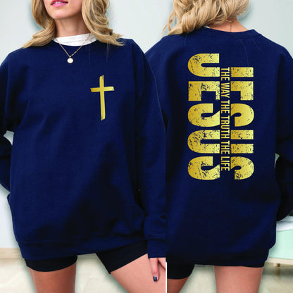 May include: Navy blue sweatshirt with a gold cross on the front and the word "JESUS" vertically on the back, along with the text "THE WAY THE TRUTH THE LIFE". The sweatshirt is a solid color.
