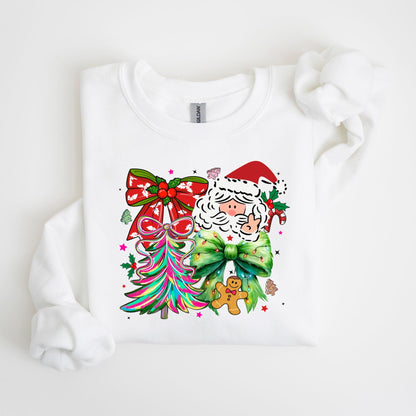 May include: White sweatshirt featuring a colorful Christmas design. The graphic includes Santa Claus, a gingerbread man, a Christmas tree, and bows. The design incorporates red, green, pink, and other bright colors, perfect for the holiday season.