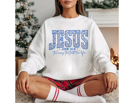 May include: White sweatshirt with the word "JESUS" in blue floral print. Below the word "JESUS" is the text "JOHN 14:6" and "the way the truth the life" in blue script. The sweatshirt is a crew neck style.