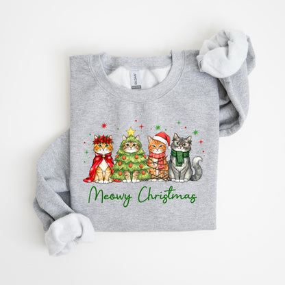 May include: A gray sweatshirt featuring four cats dressed for Christmas. One cat wears a red cape and wreath, another is a Christmas tree, and the others wear a Santa hat and scarf. The words "Meowy Christmas" are written in green.