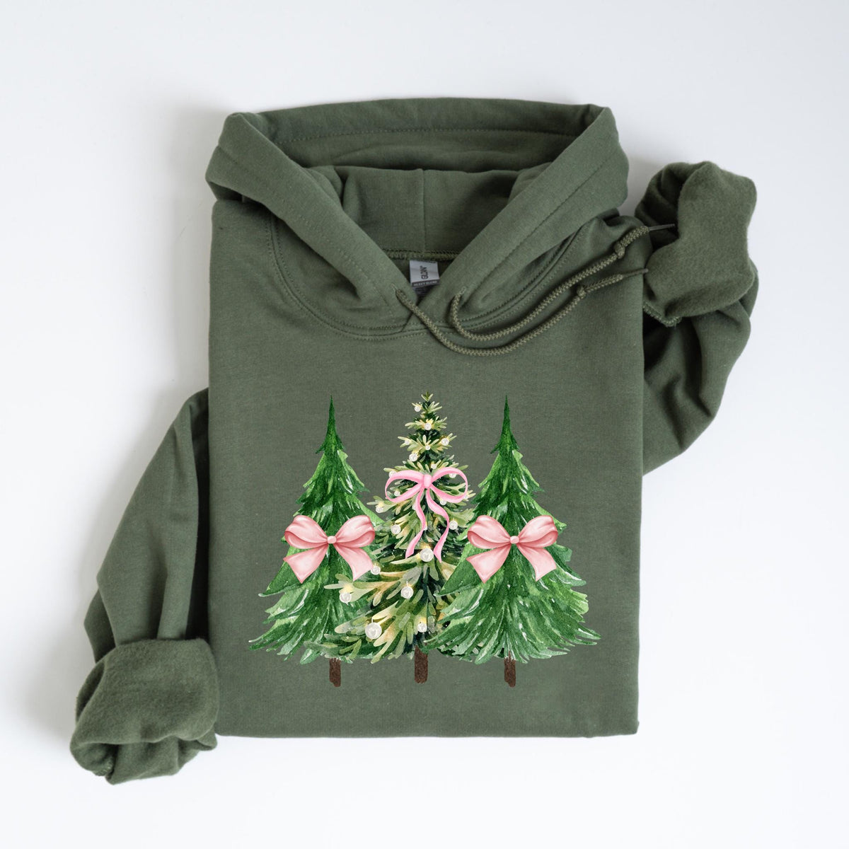May include: Olive green hoodie featuring a watercolor design of three Christmas trees. The trees are green with pink bows and a central tree with pink accents. The hoodie has a drawstring hood and long sleeves, perfect for the holiday season.