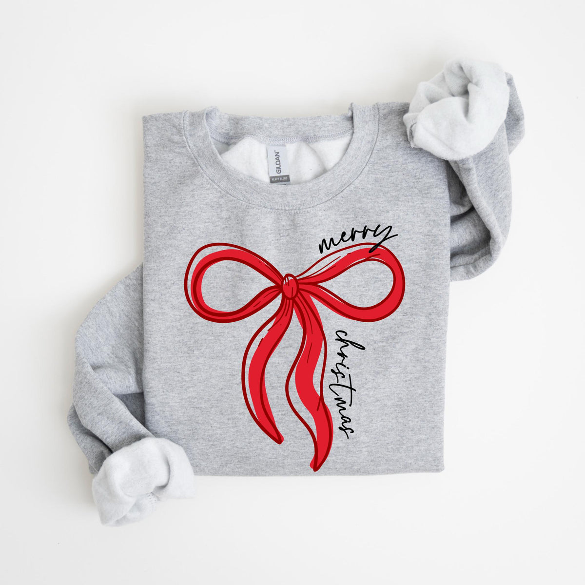 May include: A light gray sweatshirt with a red bow graphic and the words "merry christmas" in black script. The long-sleeved shirt has a crew neck and a soft, fleecy interior. The design is simple and festive.
