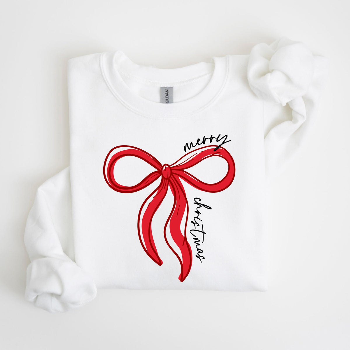 May include: White sweatshirt featuring a large red bow design with the words "merry christmas" in black script. The bow has a hand-drawn style with red outlines and shading. A festive holiday-themed apparel item.