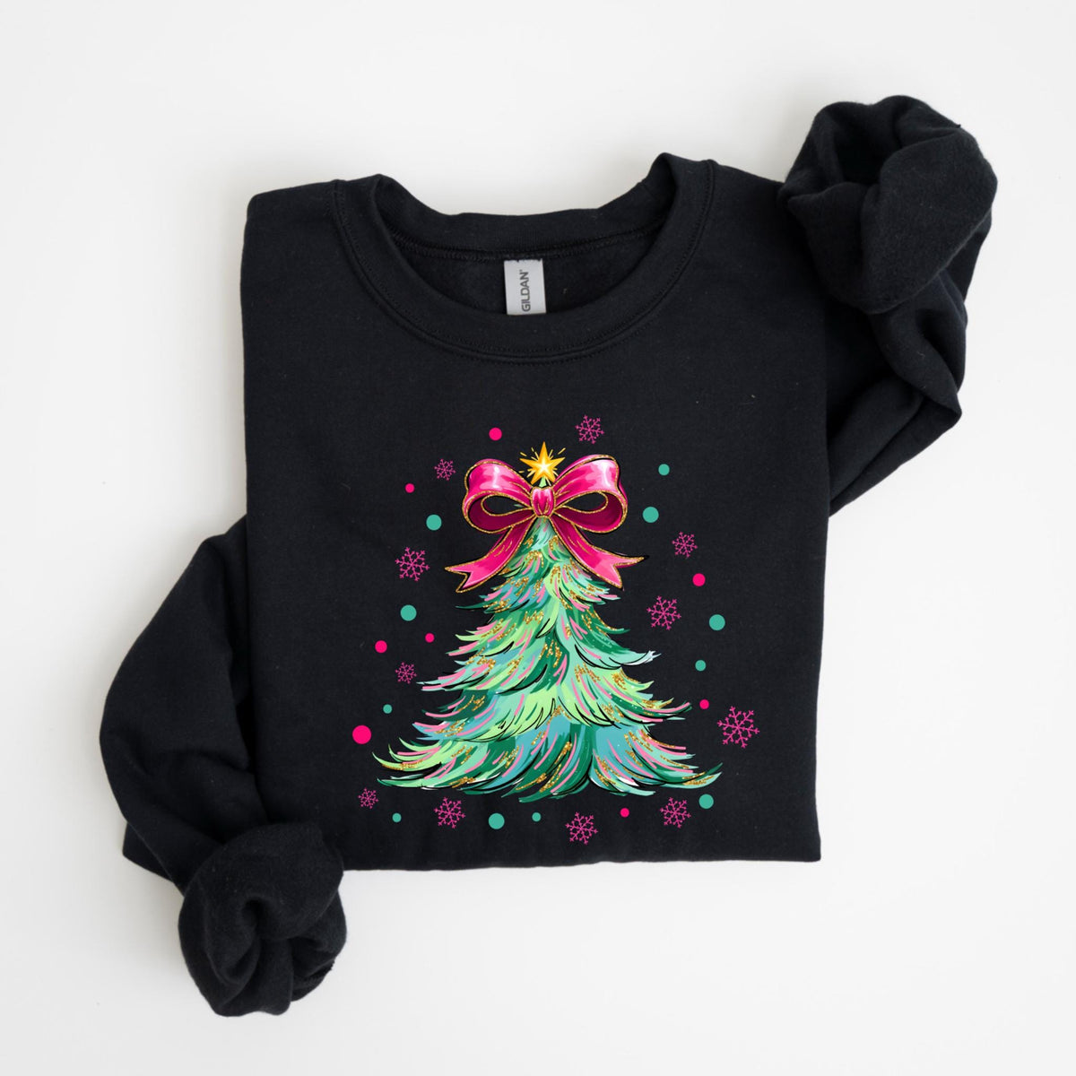 May include: Black sweatshirt featuring a colorful Christmas tree design. The tree is decorated with a pink bow, gold star, and colorful accents. Pink and teal snowflakes are scattered around the tree.