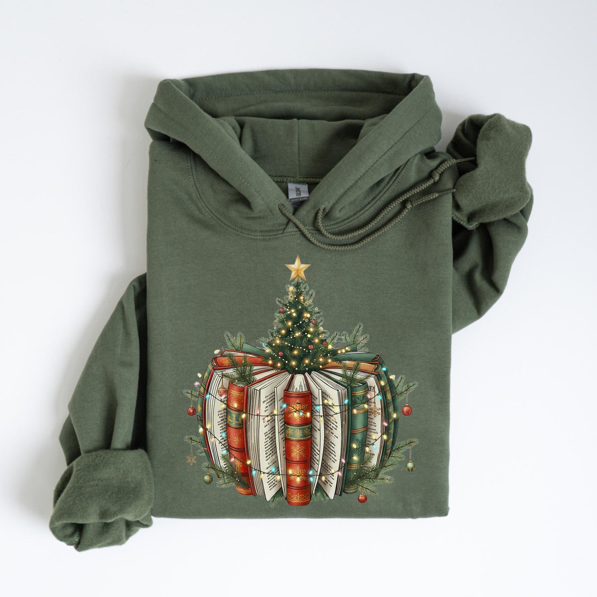 May include: Olive green hoodie featuring a Christmas tree design atop a stack of books. The books are red, green, and white, adorned with fairy lights and a star on top of the tree. The hoodie has a drawstring hood and long sleeves.