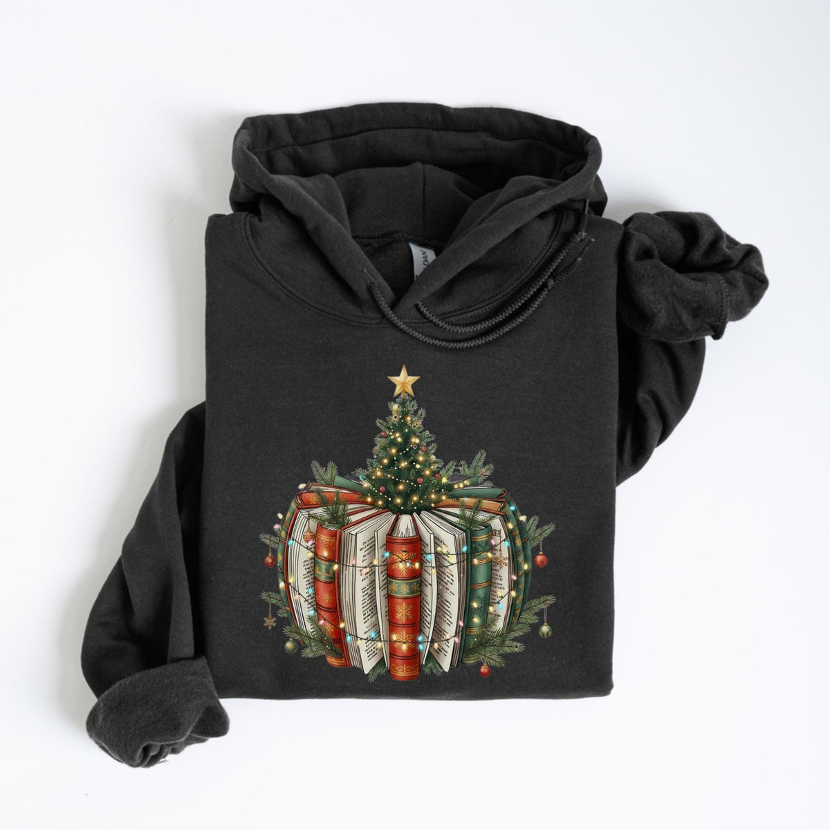 May include: Dark gray hoodie featuring a Christmas tree design atop a stack of books. The tree is adorned with a gold star and string lights. The books are red, green, and white, with festive greenery and ornaments.