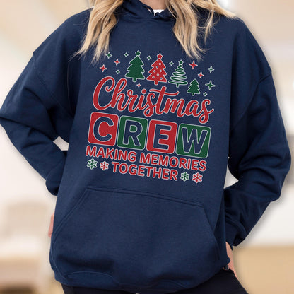 May include: A navy blue hooded sweatshirt featuring a graphic print with the text "Christmas CREW MAKING MEMORIES TOGETHER" in red, green, and white. The design includes small illustrations of Christmas trees and snowflakes above and below.