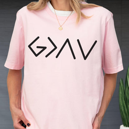 May include: A light pink short-sleeved t-shirt featuring the black graphic text G > I V centered on the chest. The shirt has a crew neckline and is worn over a white undershirt, paired with a thin gold chain necklace with a small circular pendant.