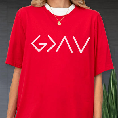 May include: A bright red short-sleeved t-shirt featuring a white graphic print on the chest that reads G > ^ V. The shirt is layered over a white crew-neck undershirt and is paired with a gold-toned chain necklace with a round pendant.