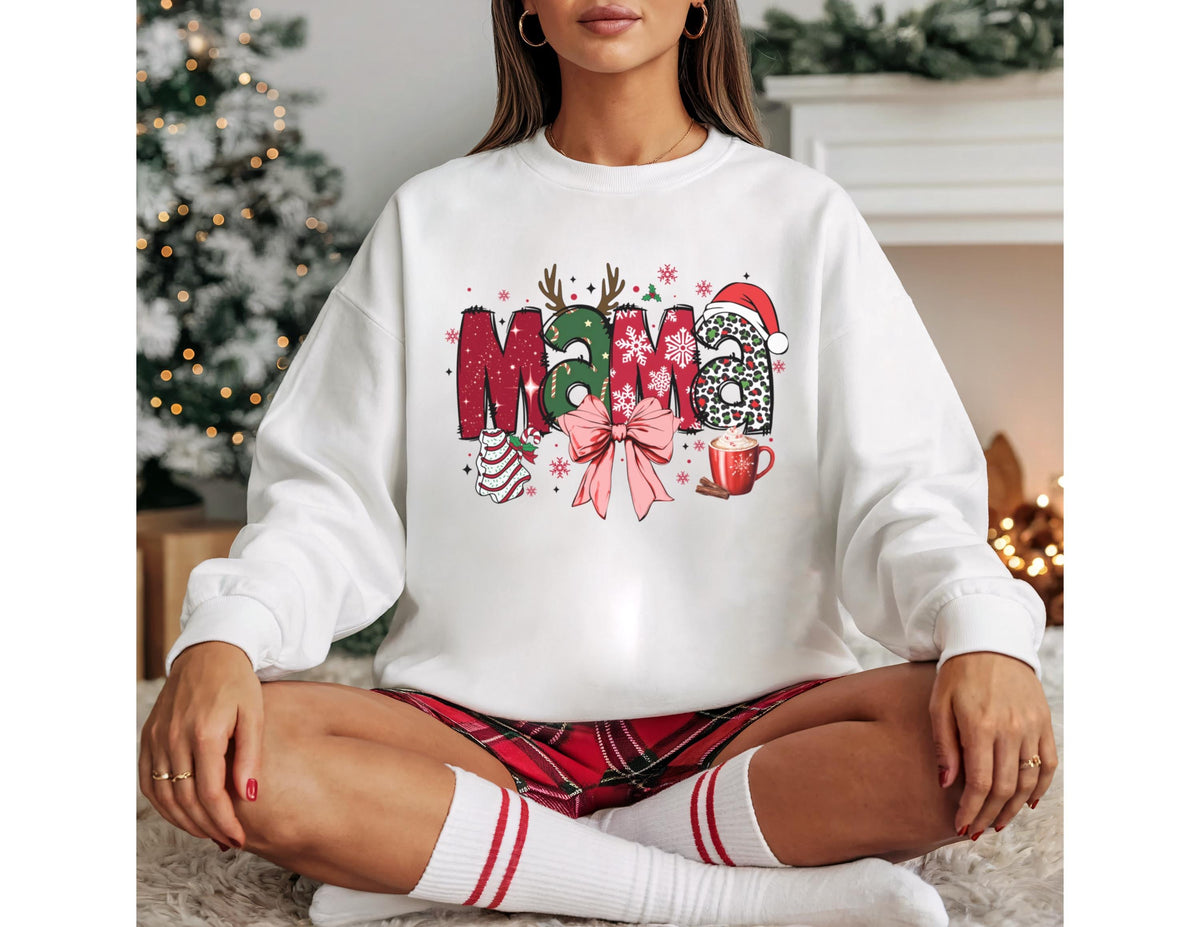 May include: White sweatshirt with the word "Mama" in a festive Christmas design. The letters are decorated with reindeer antlers, snowflakes, a Santa hat, and a bow. A cup of hot cocoa is also featured.