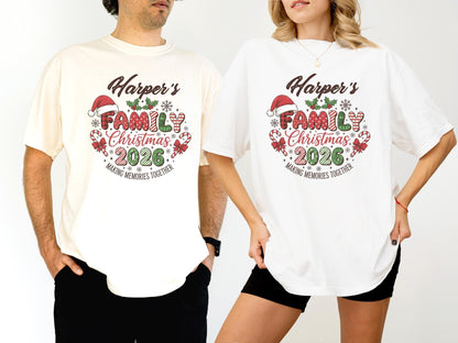 May include: Two people wearing matching t-shirts. The shirts are cream and white, featuring a Christmas design with the text "Harper's FAMILY Christmas 2026" in a festive font, with candy canes and a Santa hat.