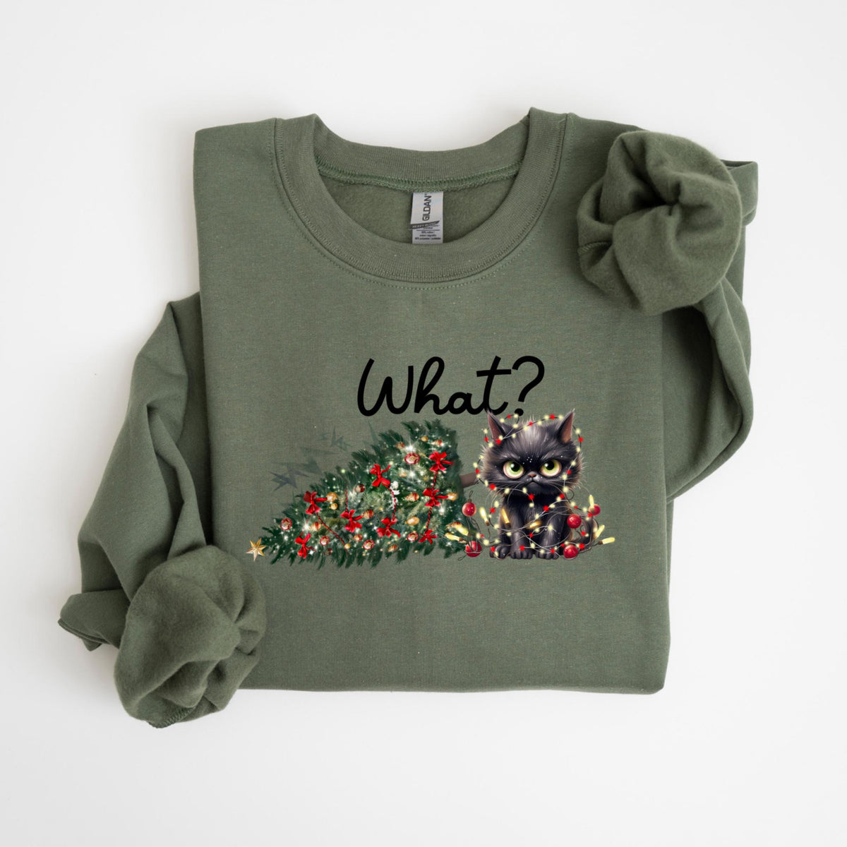 May include: Olive green sweatshirt with a graphic of a black cat tangled in Christmas lights next to a decorated Christmas tree. The word "What?" is written above the cat in black script.
